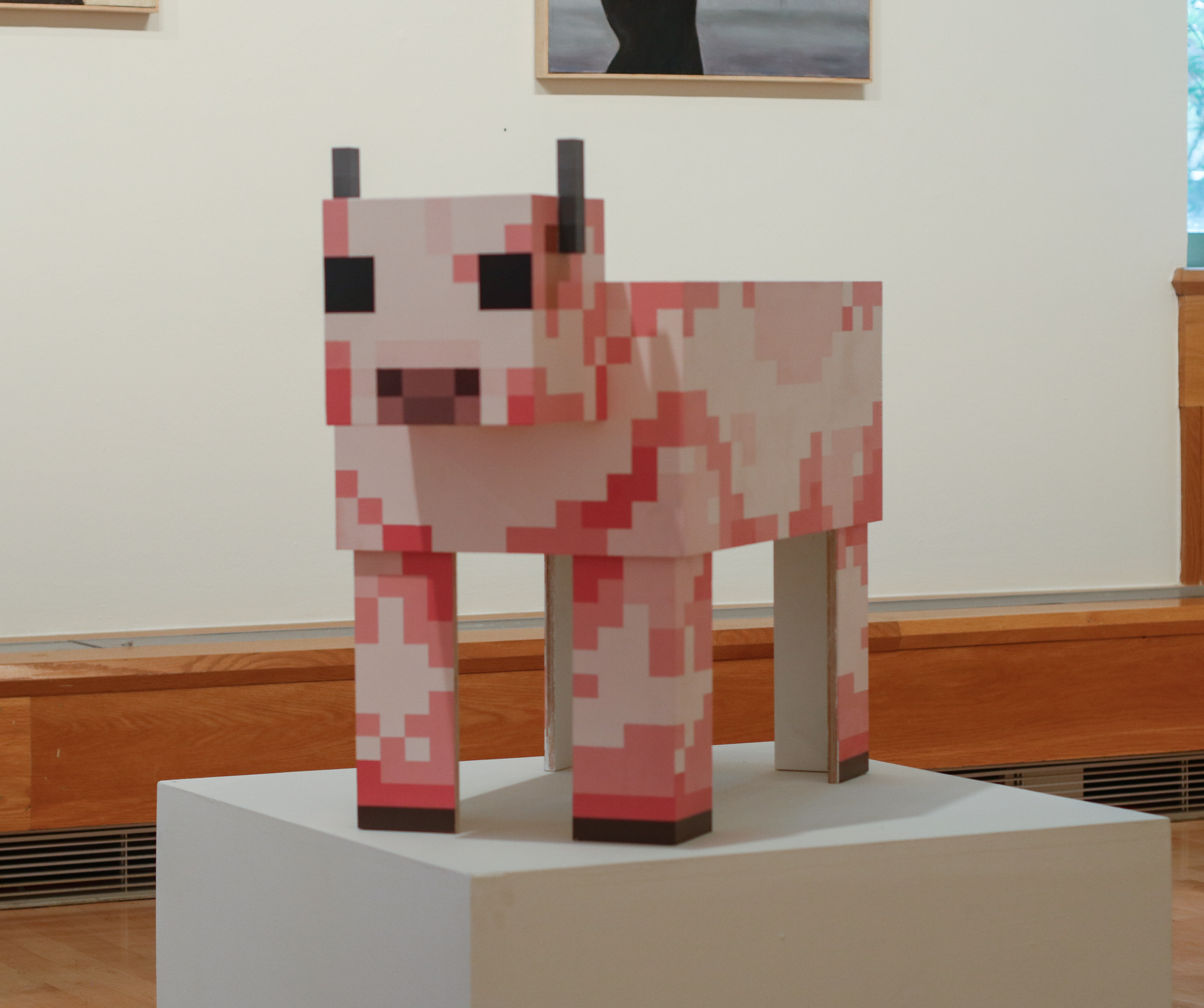 Pink Minecraft cow side table on white pedestal.