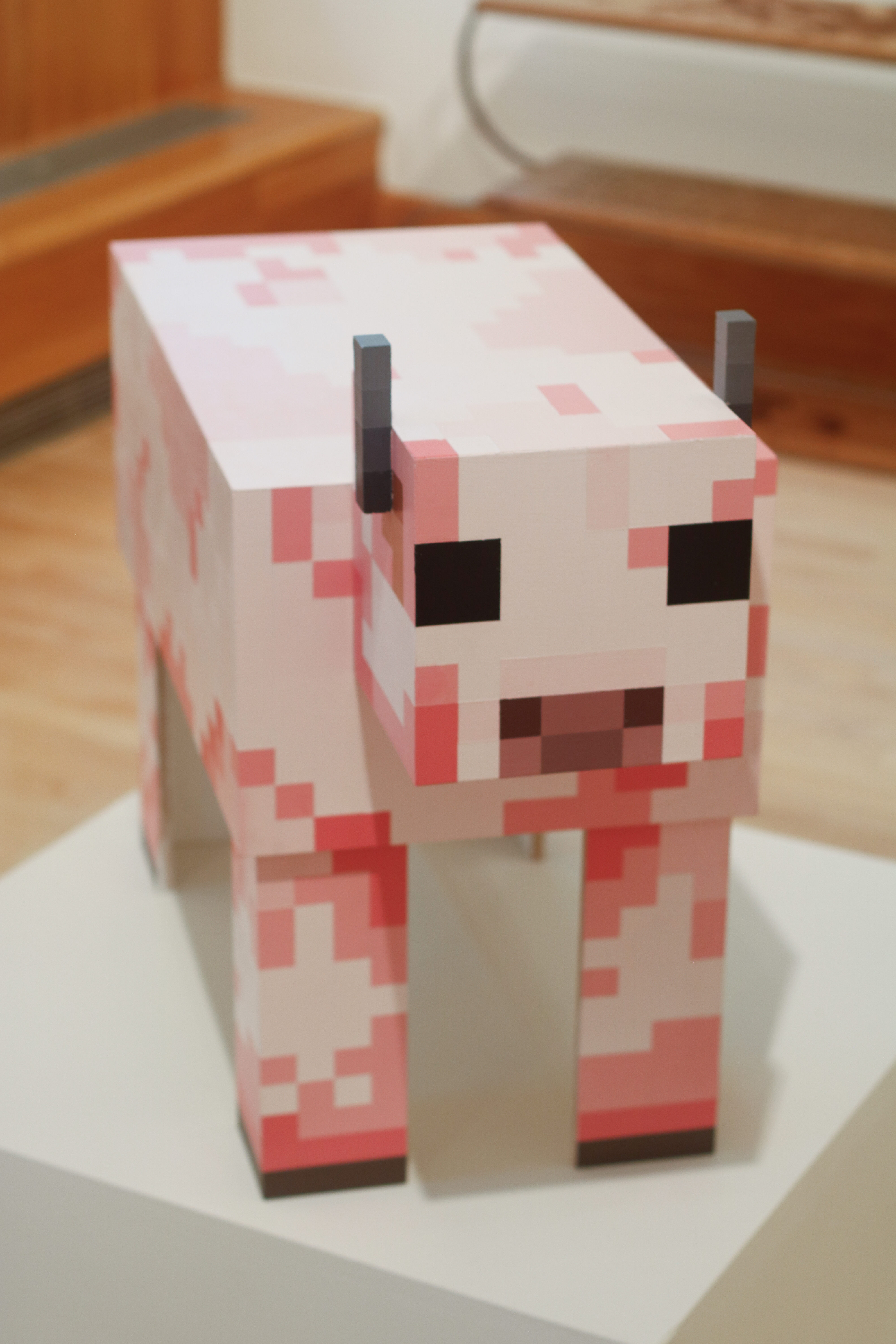 Vertical image of pink Minecraft cow side table.