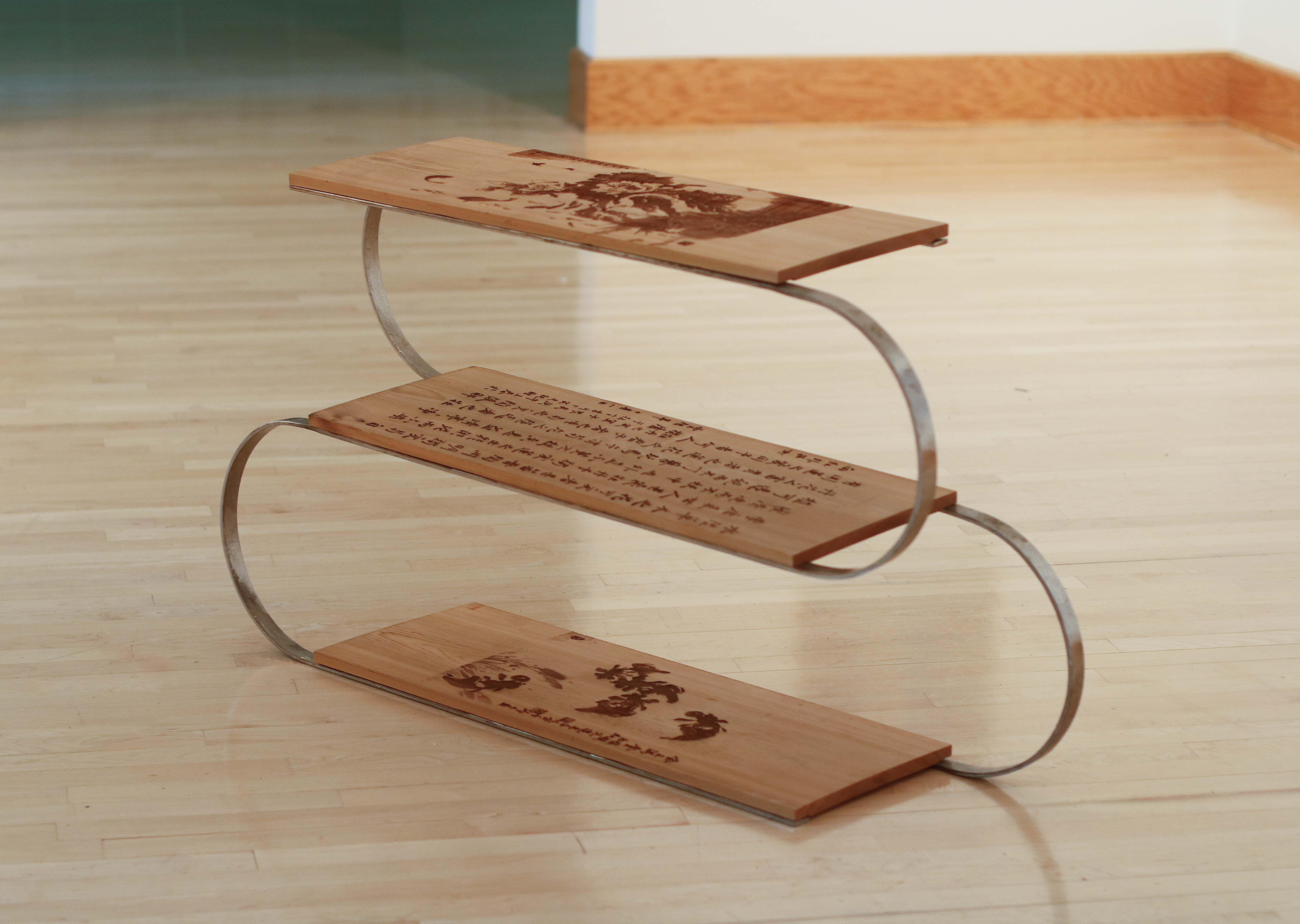 Steel and cedar shoe rack engraved with Chinese paintings.